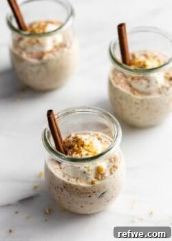 Carrot cake overnight oats in 3 jars topped with yogurt and walnuts