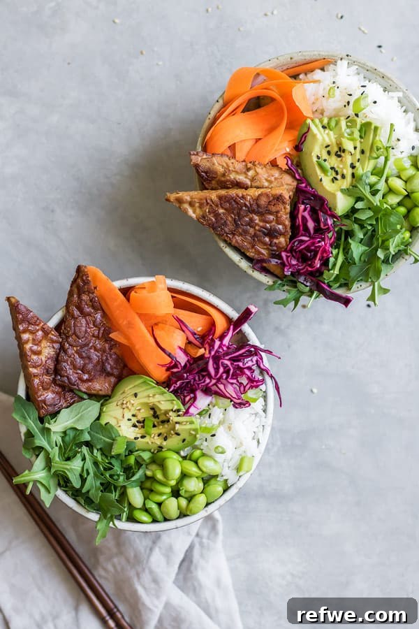 Vibrant Ginger Tempeh Poke 3 Ginger Tempeh Poke Bowl ingredients arranged artfully in a bowl, showcasing the marinated tempeh alongside rice, vibrant greens, avocado, and carrots, ready to be enjoyed.