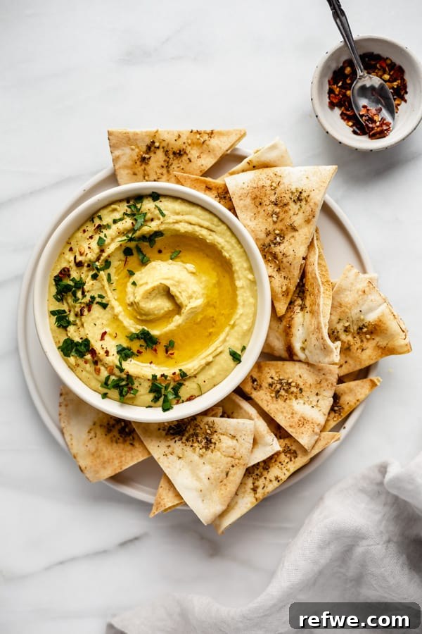 All ingredients for the curried white bean dip loaded into a food processor, ready to be blended into a smooth dip.