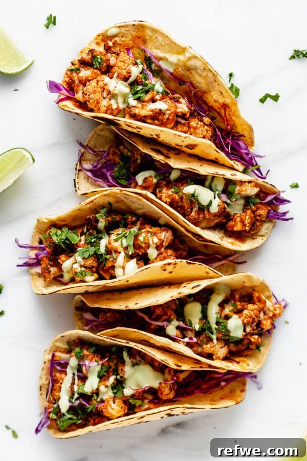 Smoky Cauliflower Tinga Tacos 5 A spread of five vibrant cauliflower tinga tacos, artfully arranged and ready to be enjoyed.
