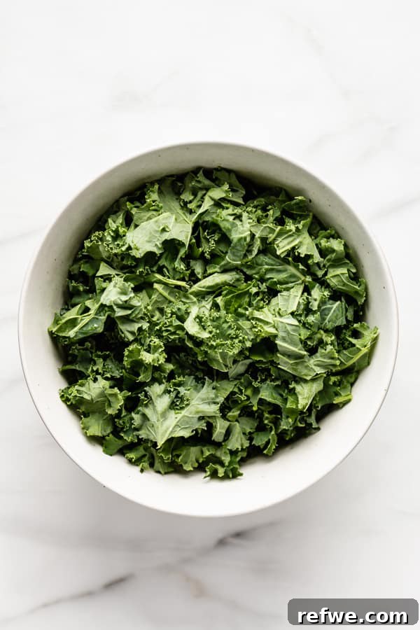 Perfectly Tender Massaged Kale Salad 4 Close-up of fresh kale leaves before massaging, showing their vibrant green color and firm texture.