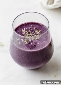 A blueberry avocado smoothie topped with hemp seeds