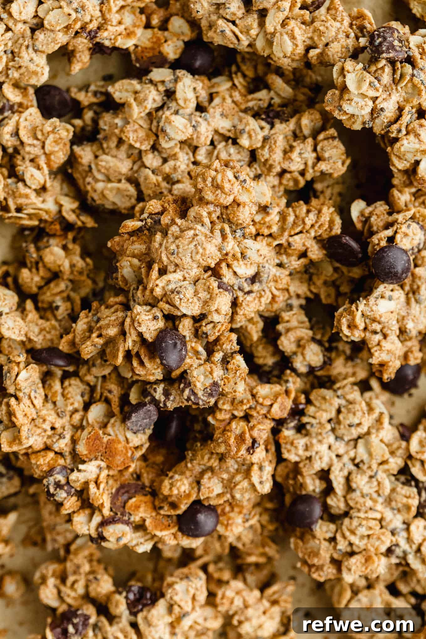 Chocolate Chip Cookie Crunch Granola 2 Crispy cookie dough granola clusters generously studded with melted chocolate chips, presented in an aesthetic bowl.