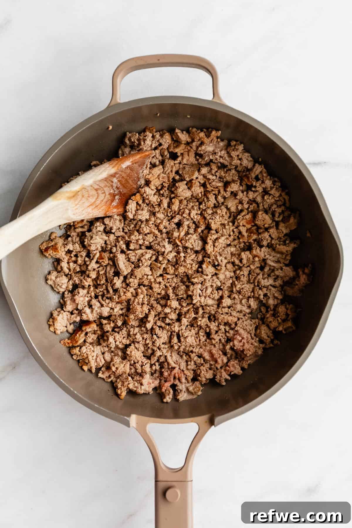 Ground Turkey and Sweet Potato Taco Skillet Recipe 4 Ground turkey in a taupe pan.