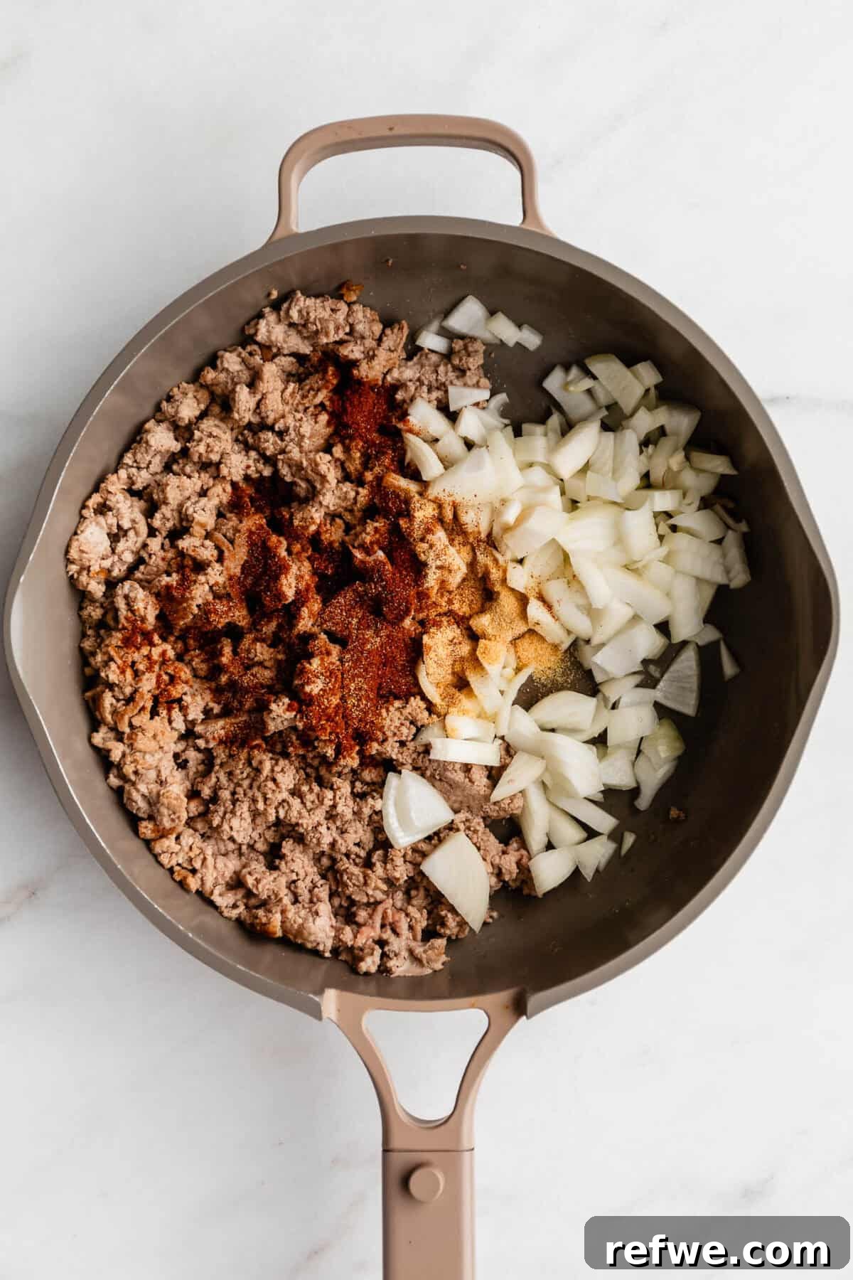 Ground Turkey and Sweet Potato Taco Skillet Recipe 5 ground turkey, onion and seasoning in a taupe pan.
