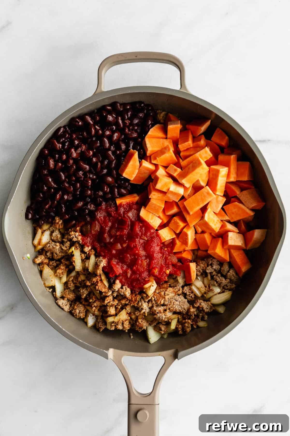Ground Turkey and Sweet Potato Taco Skillet Recipe 6 ground turkey, sweet potato, salsa and black beans in a taupe pan.