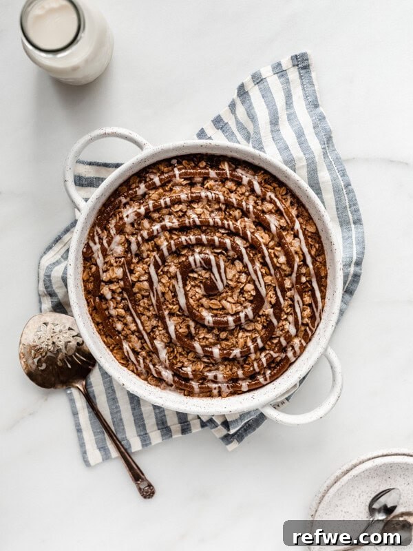 Key Lime Pie Overnight Oats Recipe for Creamy Citrus Breakfast 11 baked oatmeal in a round baking dish on a striped blue napkin topped with cinnamon sugar swirl