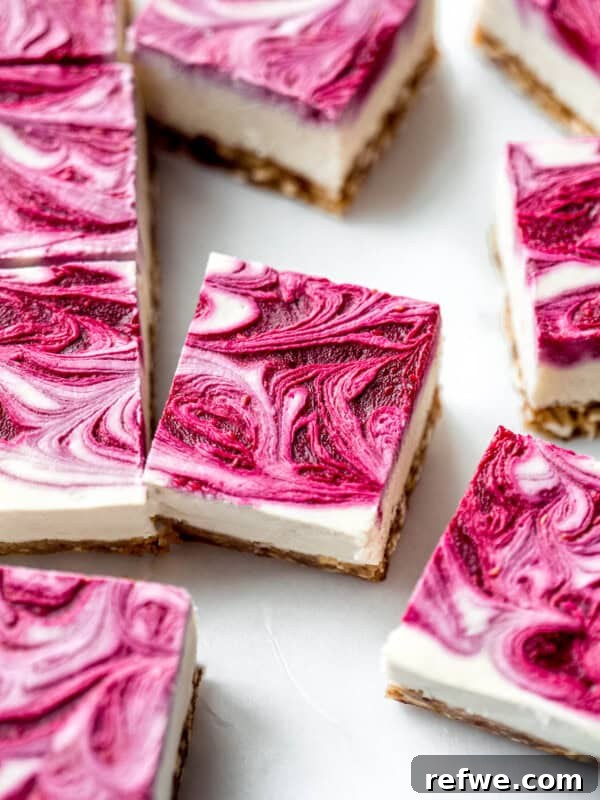 Cookie Dough-Stuffed Dates: Sweet Appetizer with Chocolate Chips 13 Vegan raspberry cheesecake bars with raspberry swirl on top on them