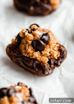 a cookie dough stuffed date on parchment paper.