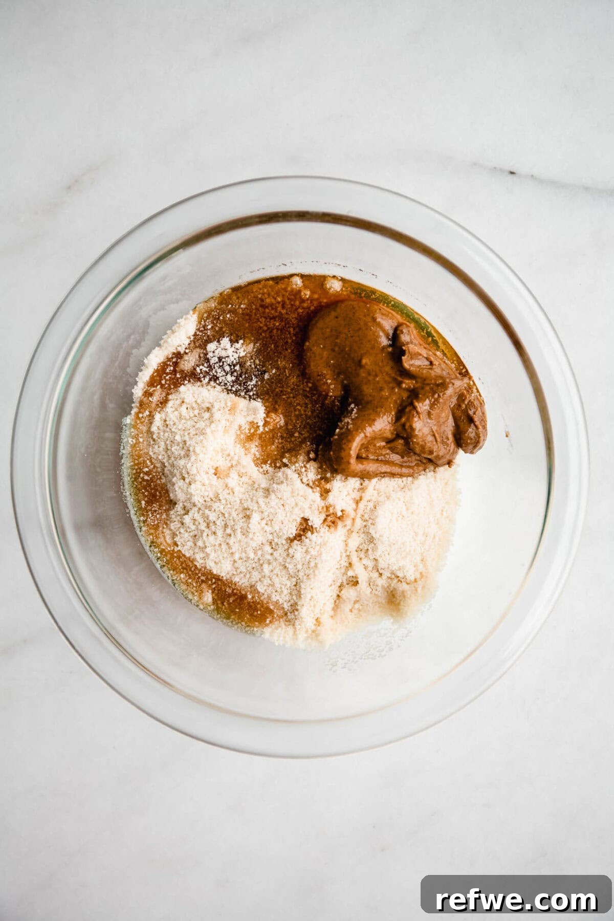 Cookie Dough-Stuffed Dates: Sweet Appetizer with Chocolate Chips 4 Almond flour, maple syrup and almond butter in a mixing bowl.