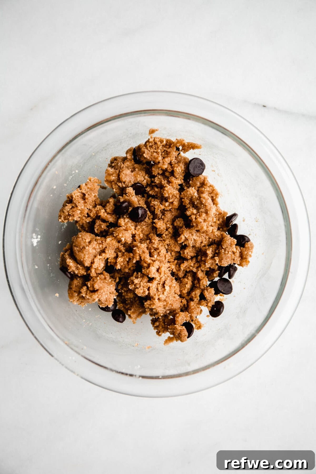 Cookie Dough-Stuffed Dates: Sweet Appetizer with Chocolate Chips 7 no bake cookie dough with chocolate chips in a mixing bowl.