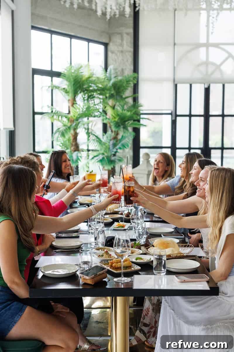Fresh Air Retreat Recap: Highlights from Atlanta, GA 7 girls toasting at a restaurant.