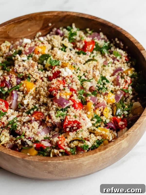 roasted vegetable quinoa salad in a wood bowl.