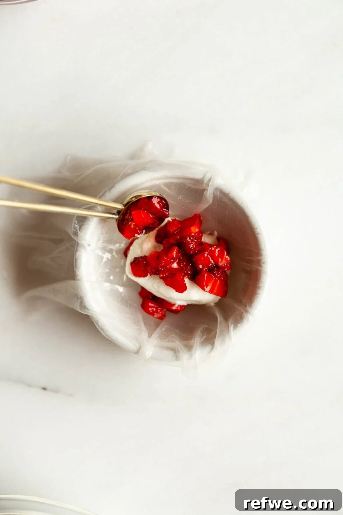 Chewy Rice Paper Mochi Recipe: Step-by-Step Homemade Treat 6 Strawberry being placed into rice paper dough to make rice paper mochi