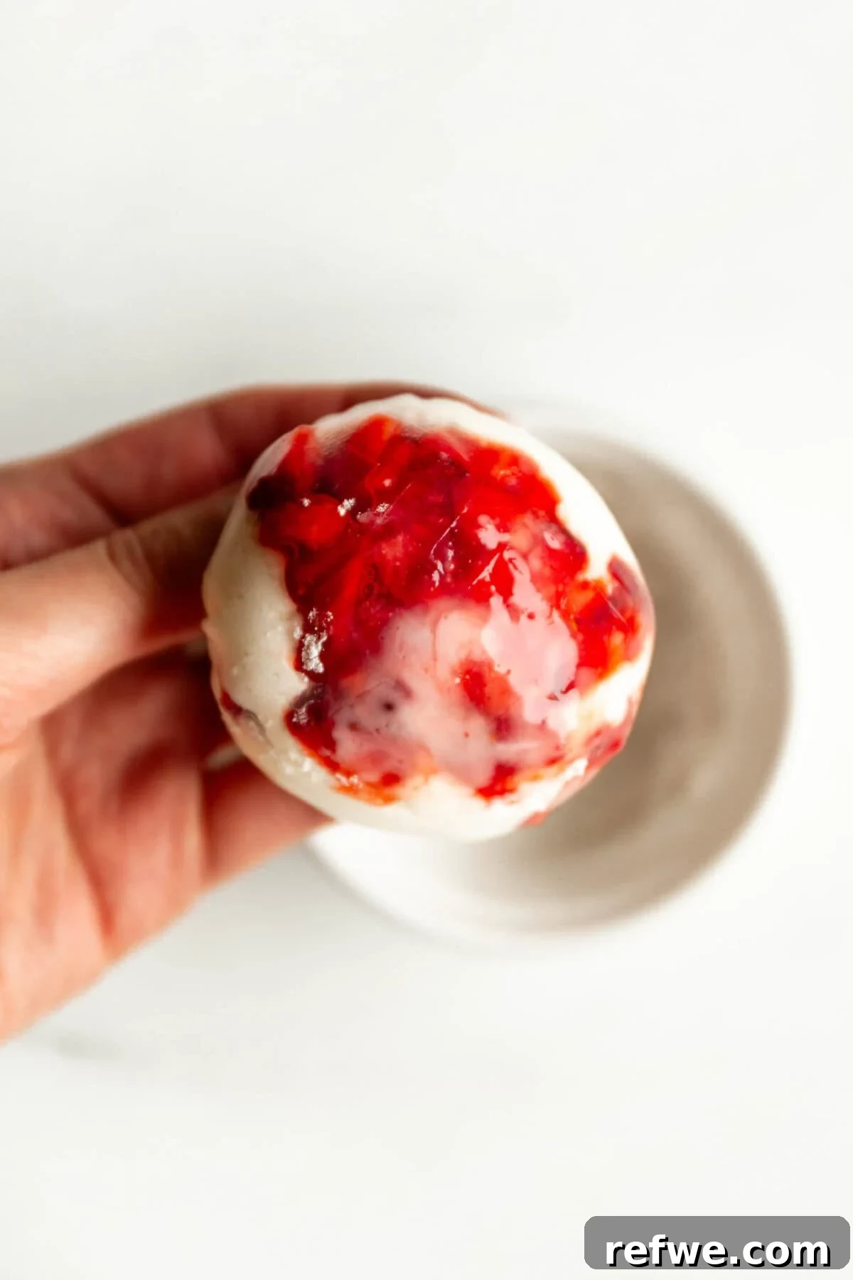 Chewy Rice Paper Mochi Recipe: Step-by-Step Homemade Treat 8 Hand holding a rice paper mochi ball with strawberry filling