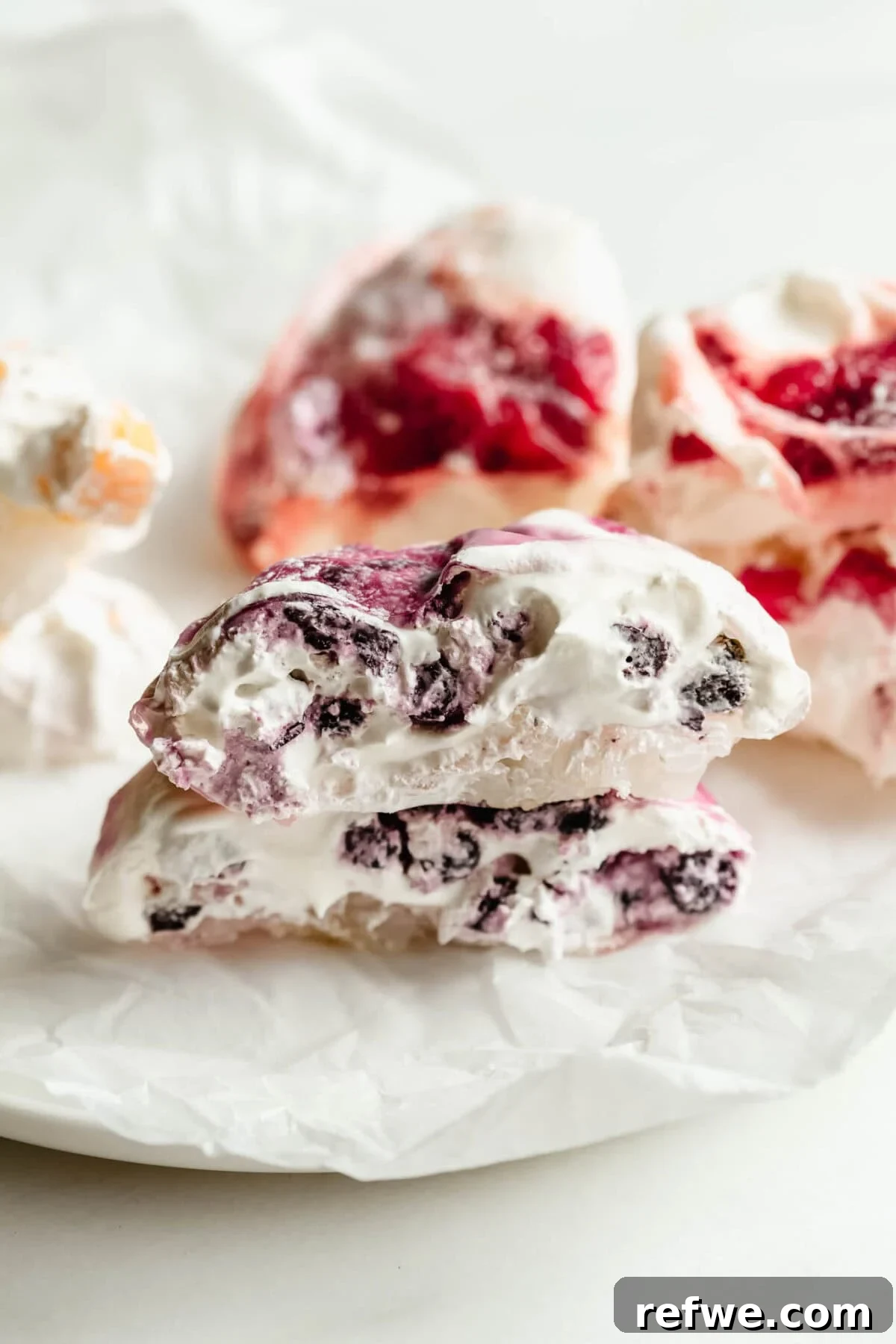 Chewy Rice Paper Mochi Recipe: Step-by-Step Homemade Treat 10 Rice paper mochi cut open to reveal blueberry filling, with mango and strawberry mochi in background