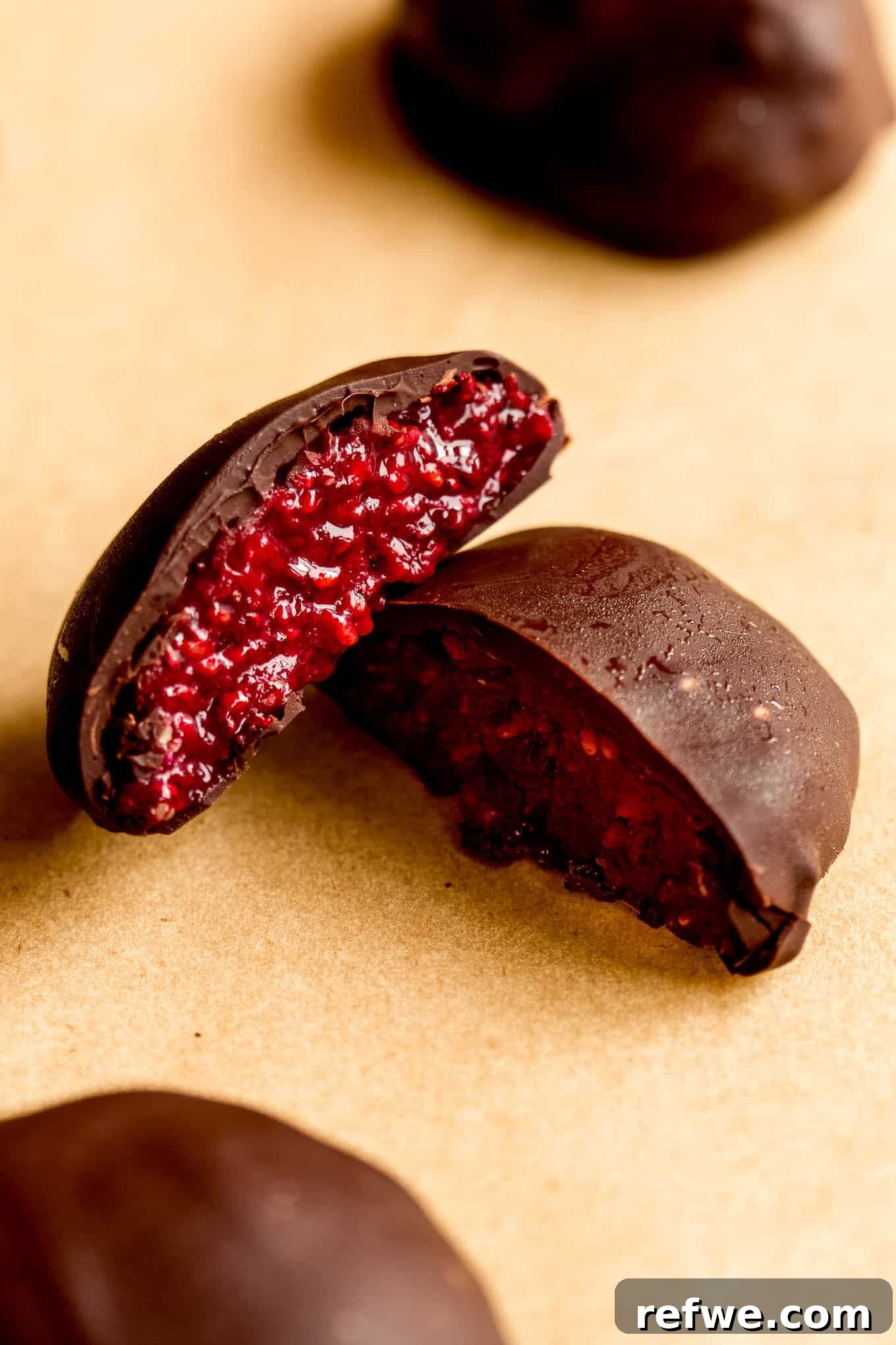 Chocolate Chia Jam Energy Bites: No-Bake Snack Recipe 11 A chocolate chia jam bite cut in half with raspberry jam filling.