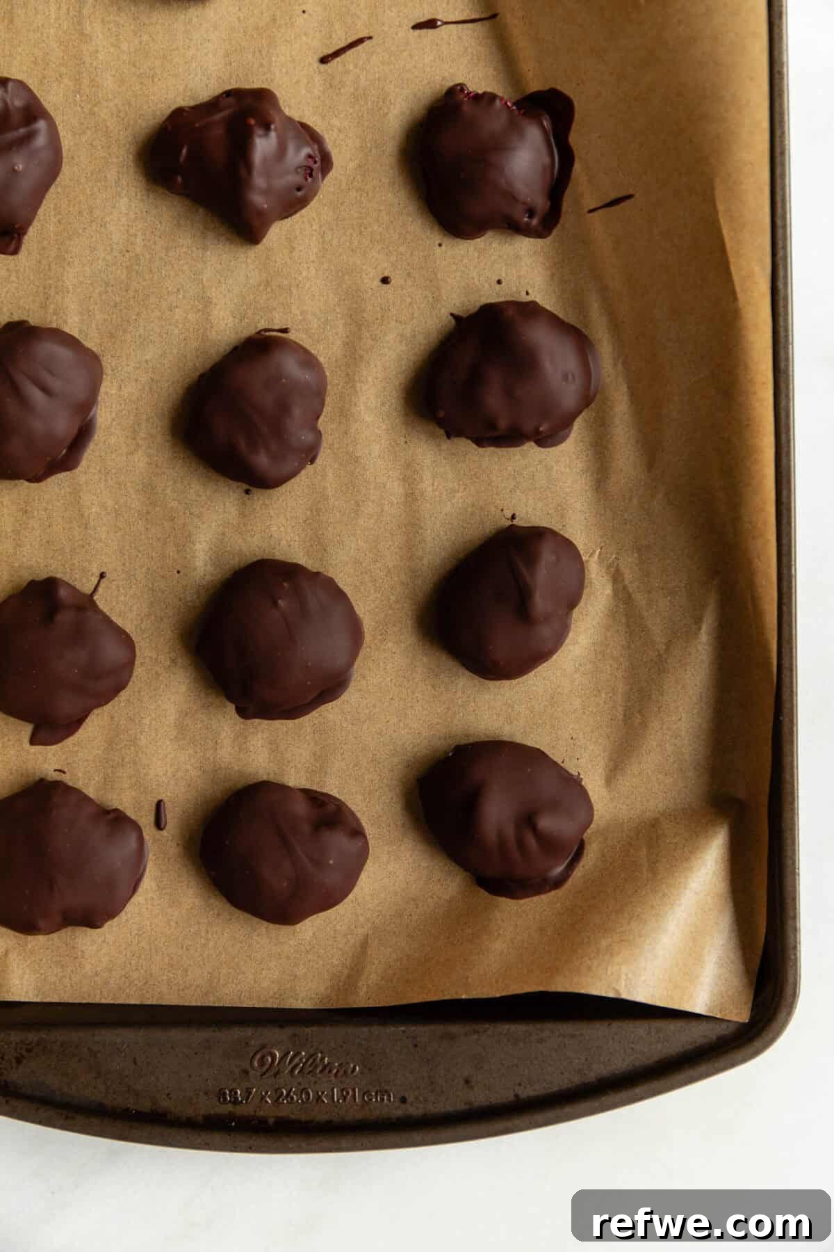Chocolate Chia Jam Energy Bites: No-Bake Snack Recipe 10 A chocolate chia jam bites on a baking sheet.