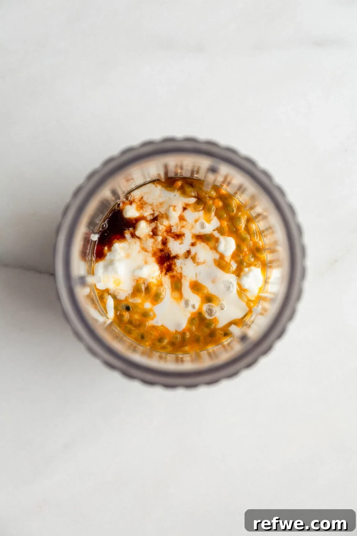 Creamy Passionfruit Chia Pudding Recipe for Breakfast & Dessert 5 Passionfruit chia pudding in a glass jar topped with yogurt and passionfruit pulp