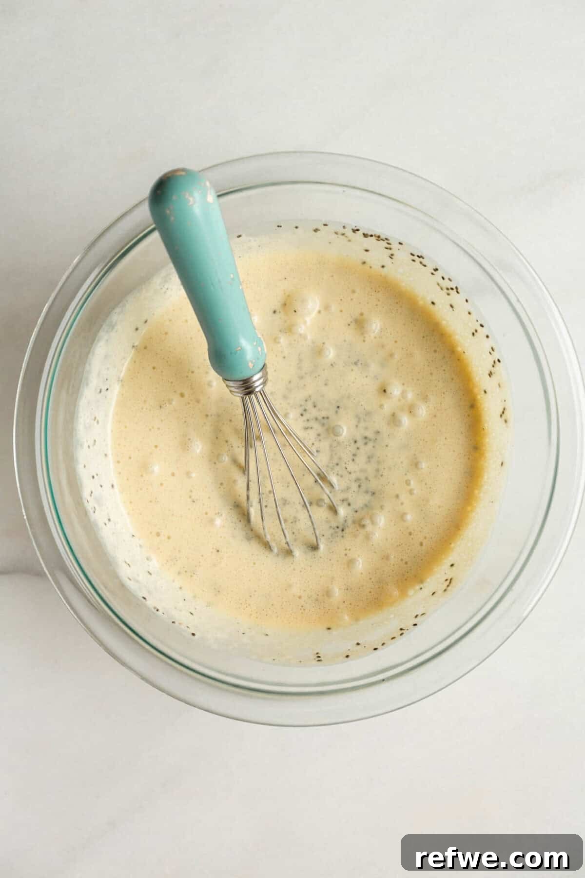 Creamy Passionfruit Chia Pudding Recipe for Breakfast & Dessert 8 Whisking chia pudding mixture in a bowl for passionfruit chia pudding