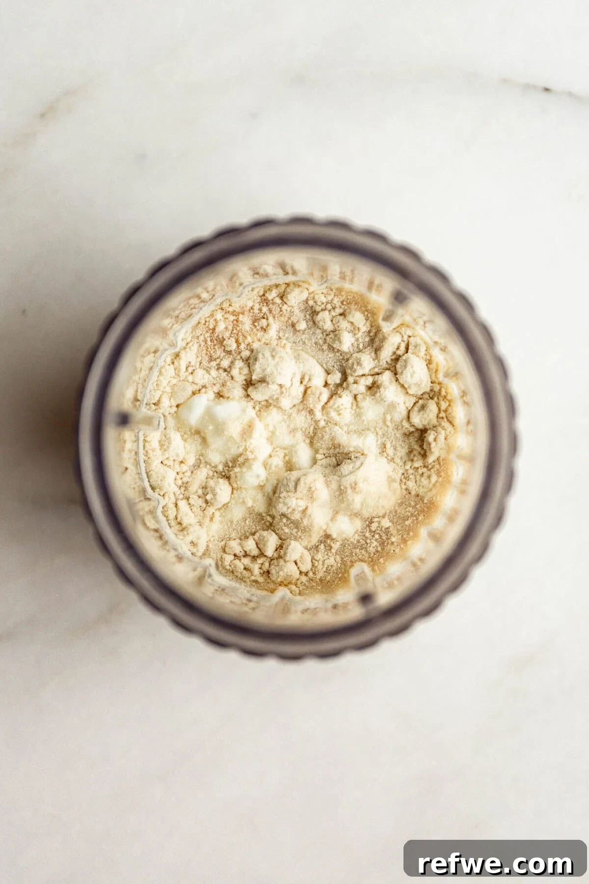 High-Protein Cookies & Cream Recipe for Ninja Creami Ice Cream 5 Top down view of a blender container with cottage cheese, milk and protein powder.