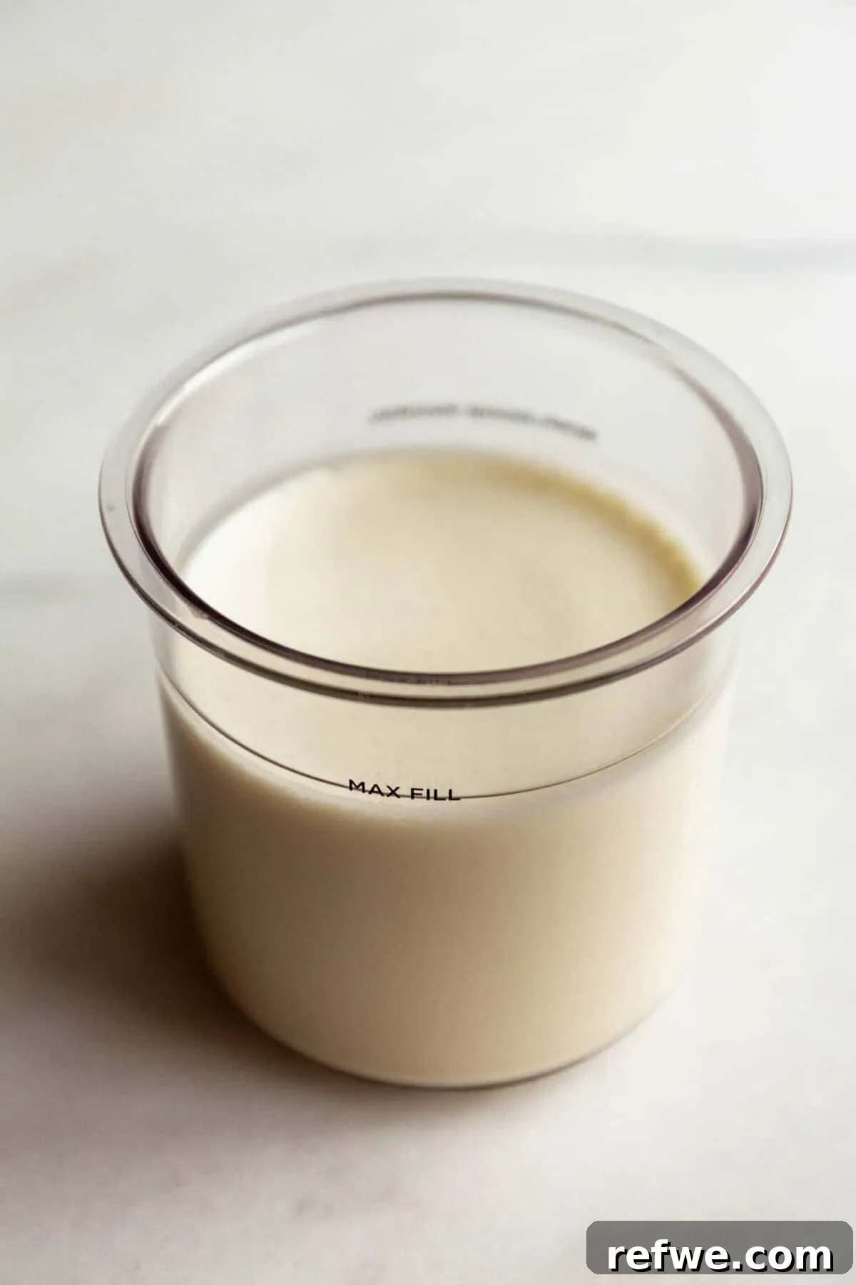 High-Protein Cookies & Cream Recipe for Ninja Creami Ice Cream 6 Cookies and cream Ninja Creami base mixture in a Ninja Creami container filled to the max fill line.
