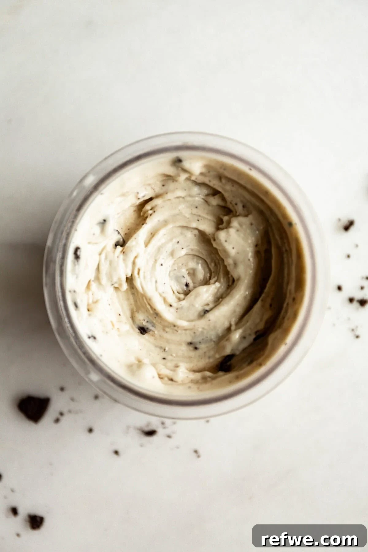 High-Protein Cookies & Cream Recipe for Ninja Creami Ice Cream 9 Top down view of cookies and cream Ninja Creami with Oreo cookie pieces mixed in, showing the creamy swirled ice cream texture.