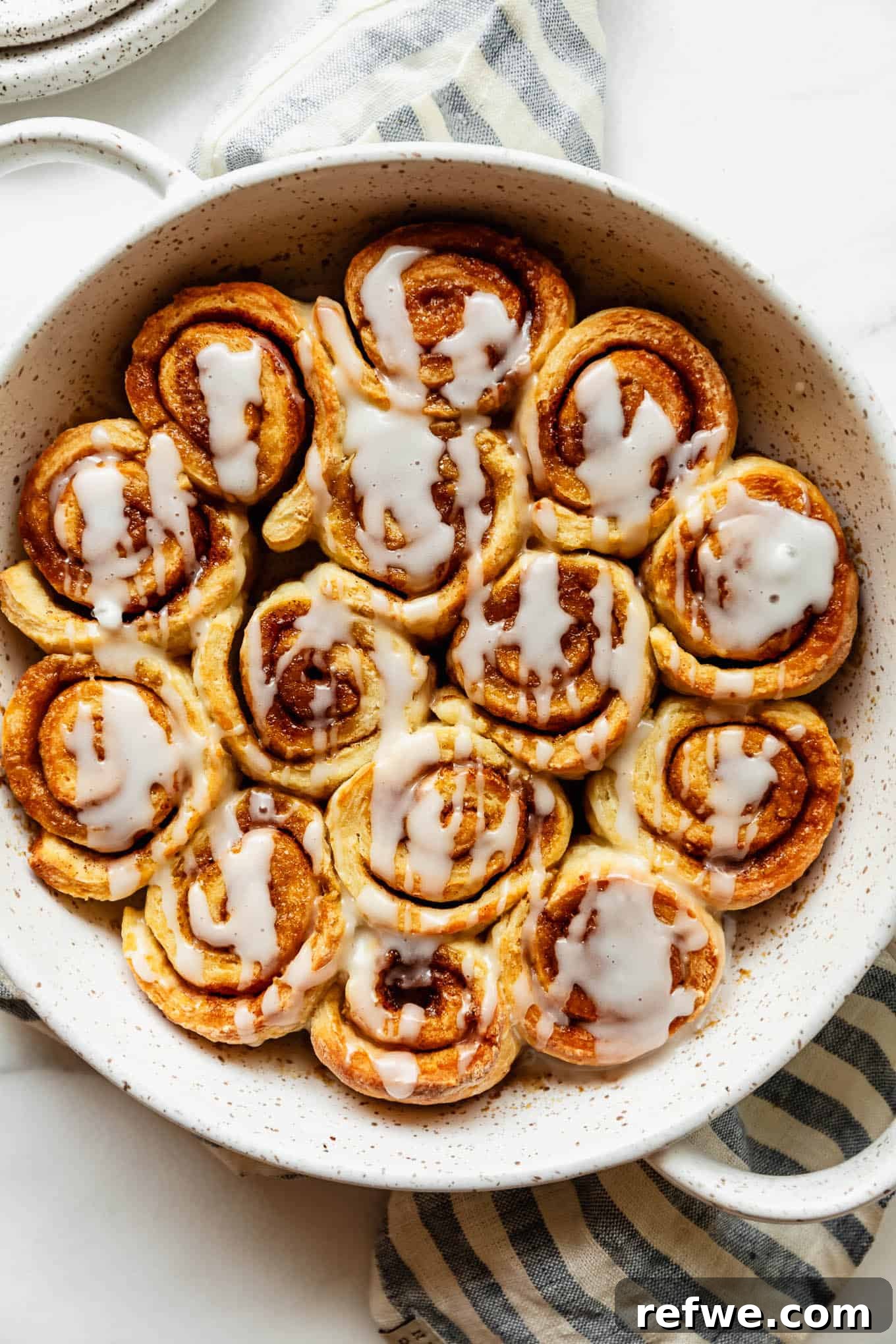 Cottage Cheese Cinnamon Rolls Recipe: Soft and Fluffy 2 Freshly baked cottage cheese cinnamon rolls in a round pan.