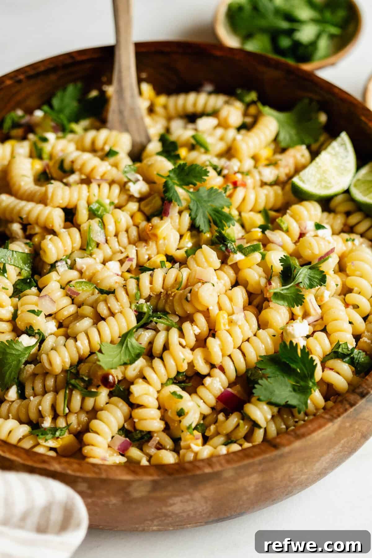 A bowl of elote pasta salad topped with cilantro.