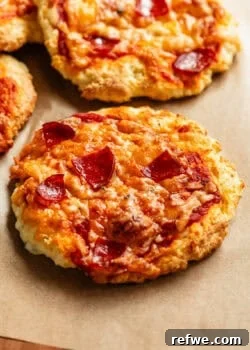 Cottage cheese pizza buns on a wood cutting board.