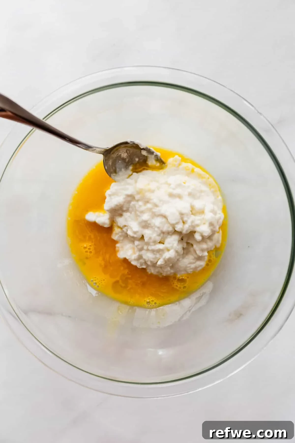 egg and cottage cheese in a mixing bowl.
