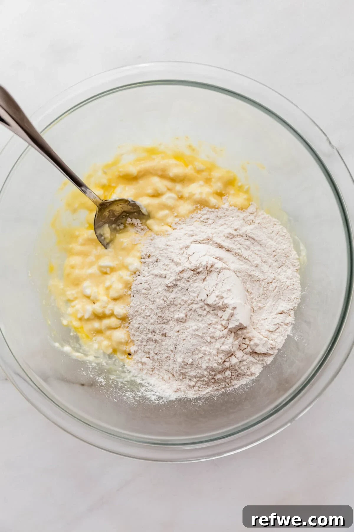 cottage cheese mixture and flour in a mixing bowl.