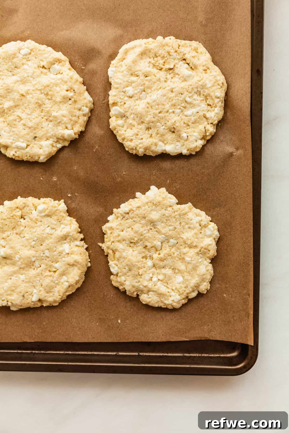 cottage cheese pizza dough buns on a baking sheet.