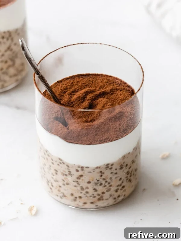 Tiramisu overnight oats in a cup topped with cocoa powder