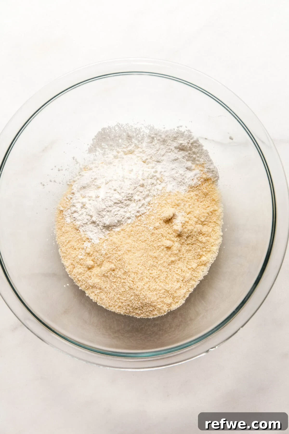 Cottage Cheese and Almond Flour Bagel Recipe 5 almond flour and cornstarch in a clear mixing bowl.