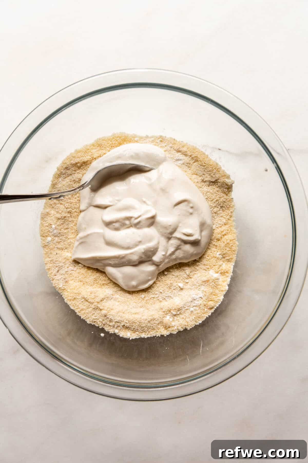 Cottage Cheese and Almond Flour Bagel Recipe 6 almond flour, cornstarch and blended cottage cheese in a clear mixing bowl.