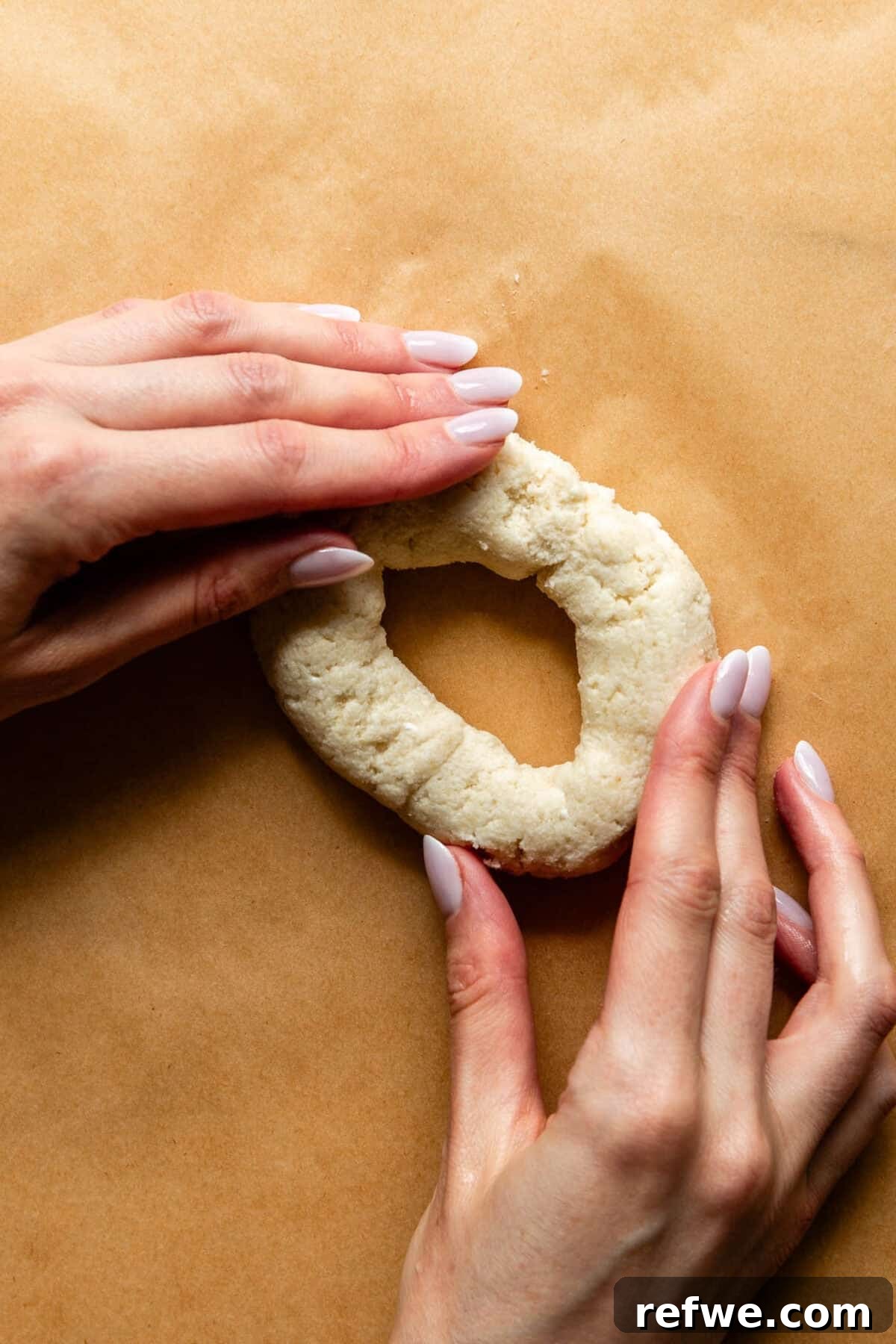 Cottage Cheese and Almond Flour Bagel Recipe 9 two hands shaping dough into a bagel.