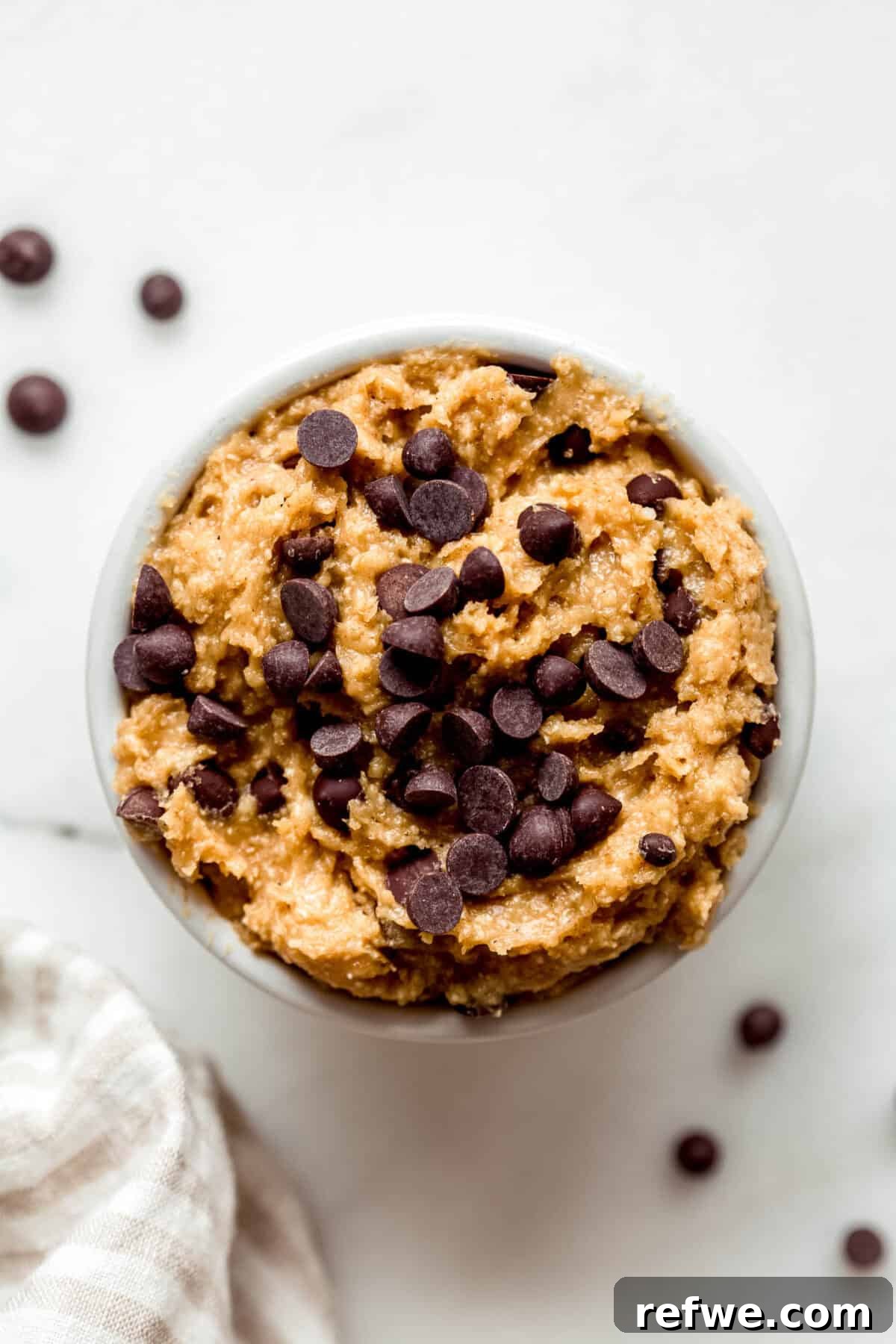 Protein-Packed Cottage Cheese Cookie Dough 7 Cottage cheese cookie dough in a ramekin topped with chocolate chips.