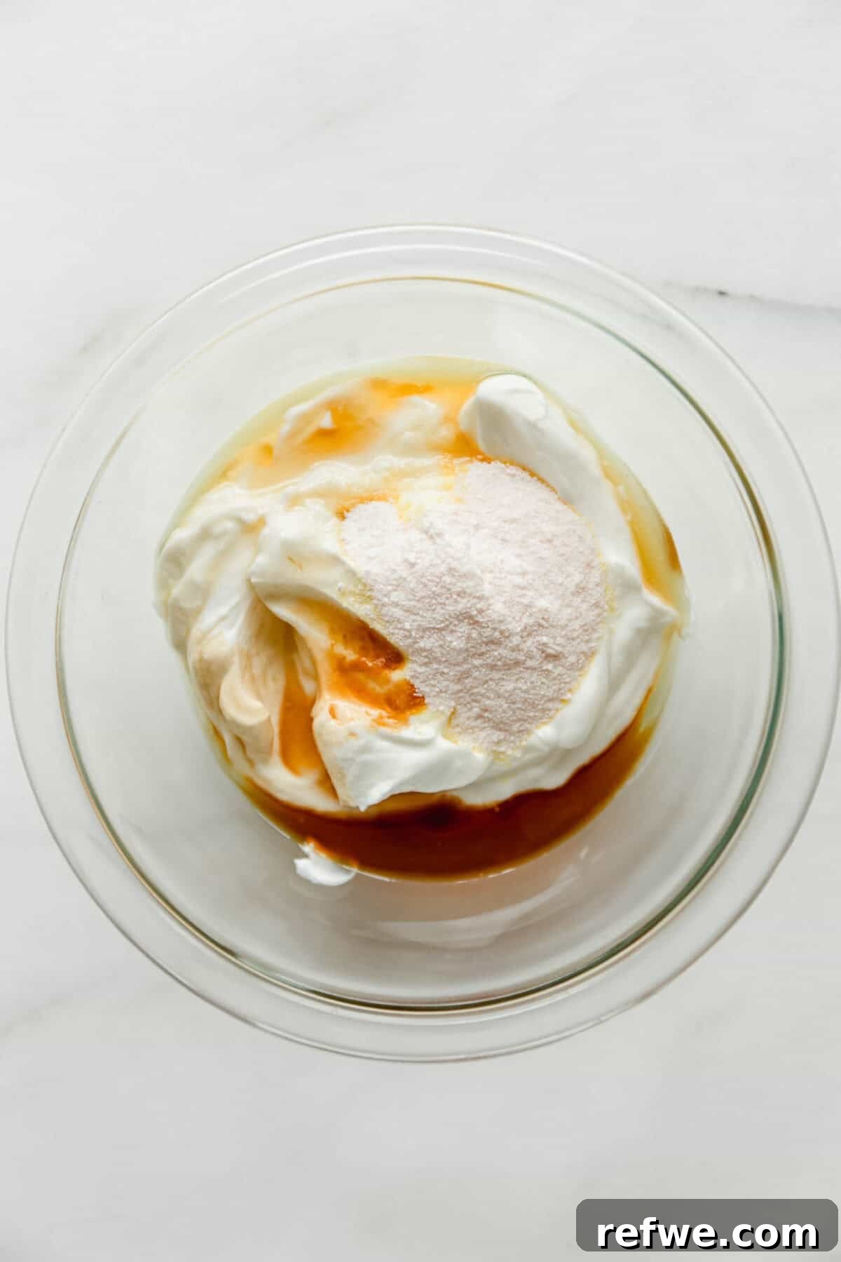 Mini Strawberry Cheesecake Pudding Jars 4 Greek yogurt, vanilla pudding mix and maple syrup in a clear mixing bowl.