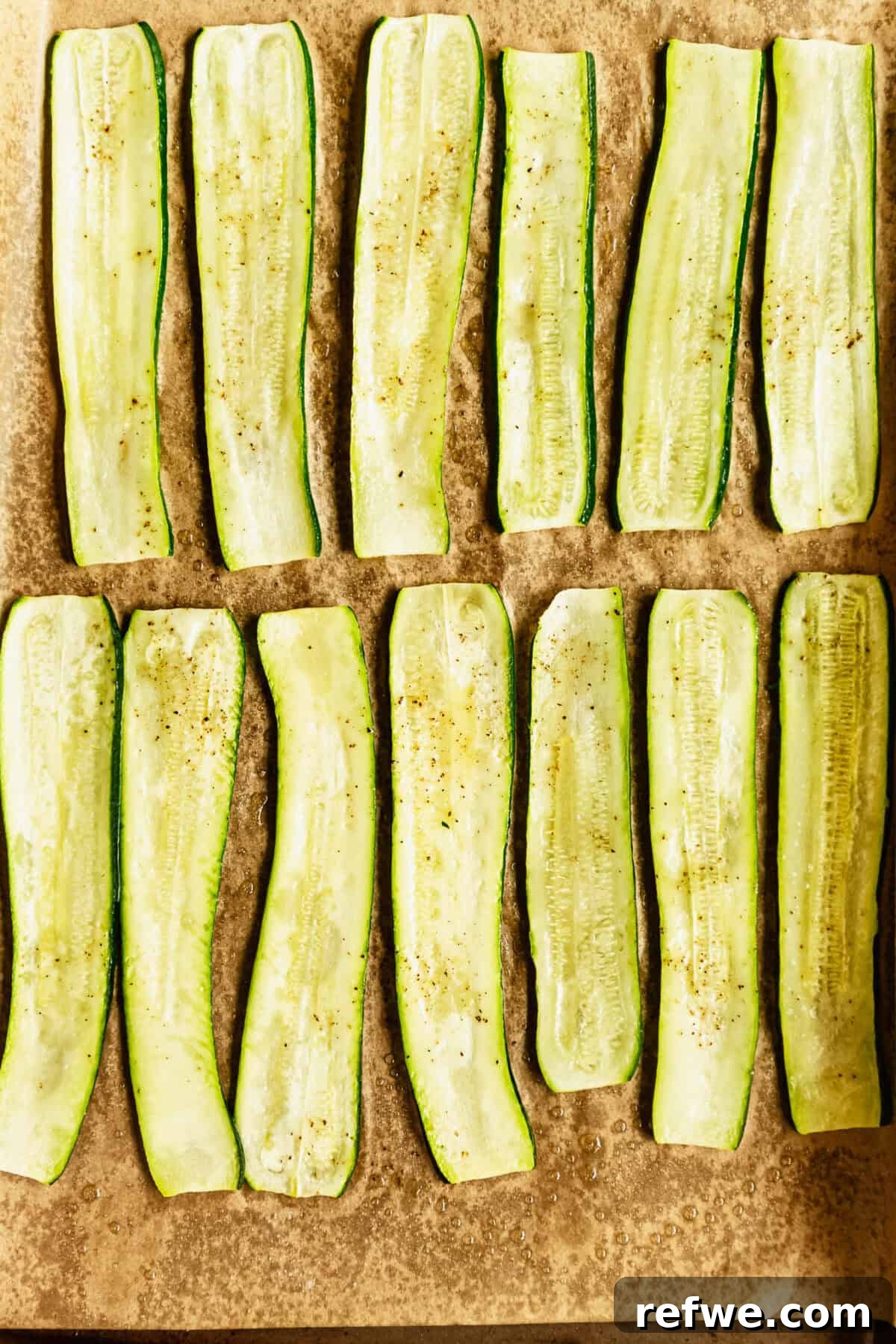 Buffalo Chicken Zucchini Roll-Ups Recipe 5 baked sliced zucchini on a baking sheet.