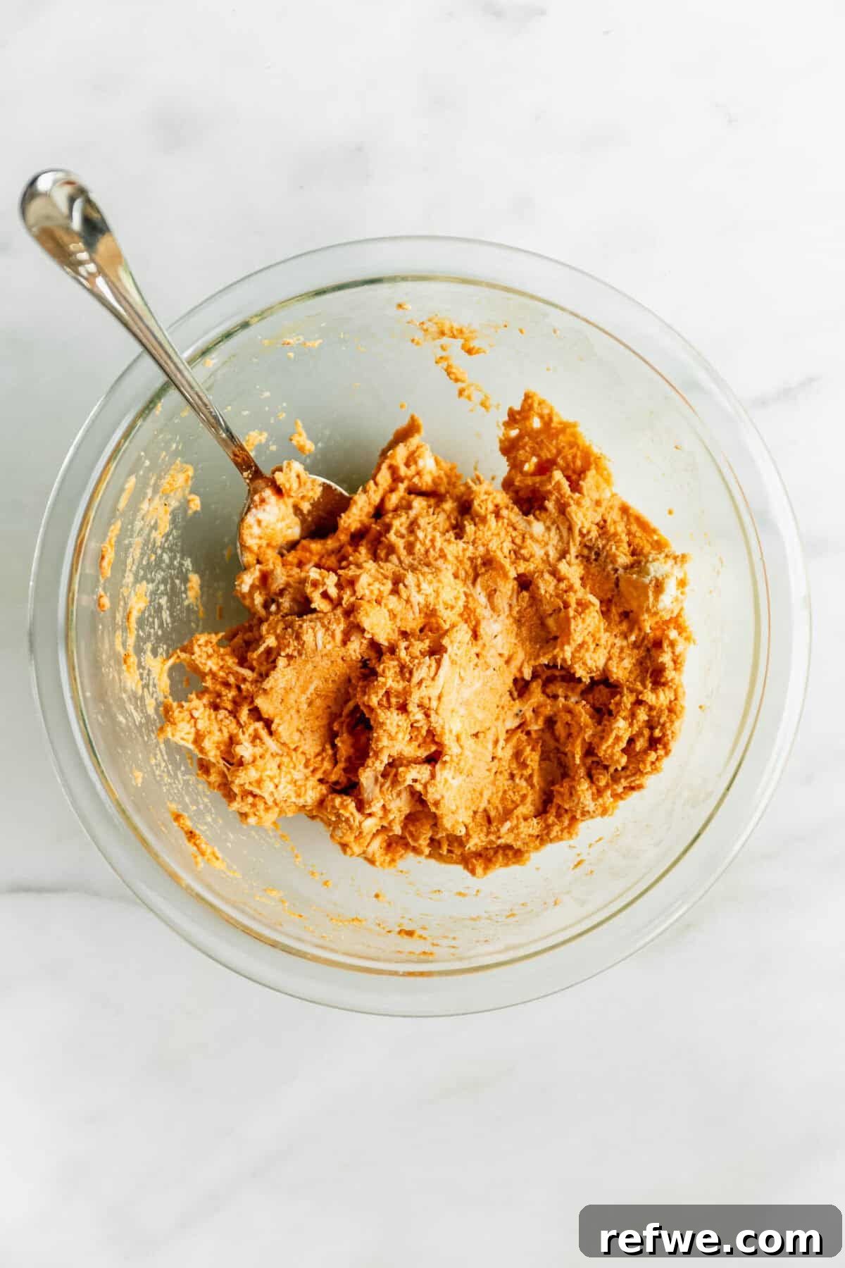 Buffalo Chicken Zucchini Roll-Ups Recipe 7 buffalo chicken ricotta filling in a clear mixing bowl.