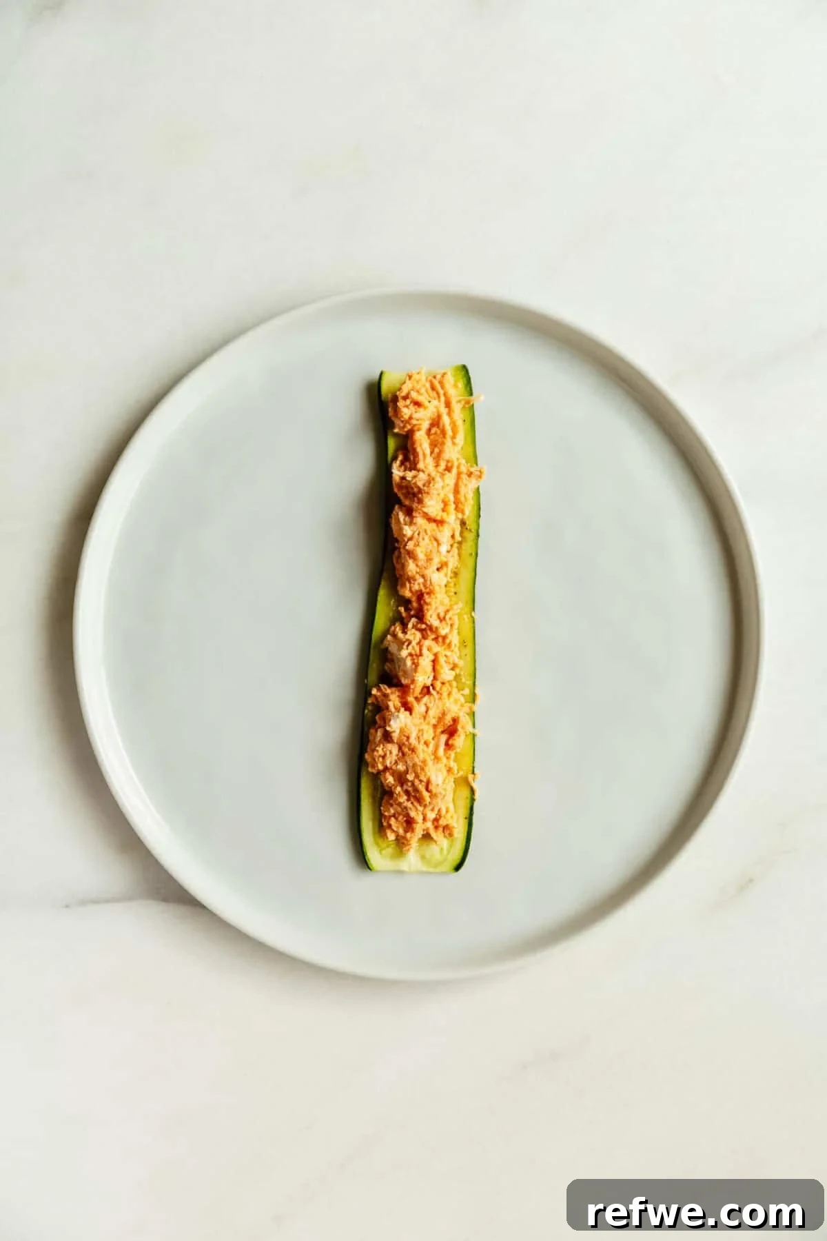 Buffalo Chicken Zucchini Roll-Ups Recipe 8 a sliced zucchini topped with buffalo chicken filling.