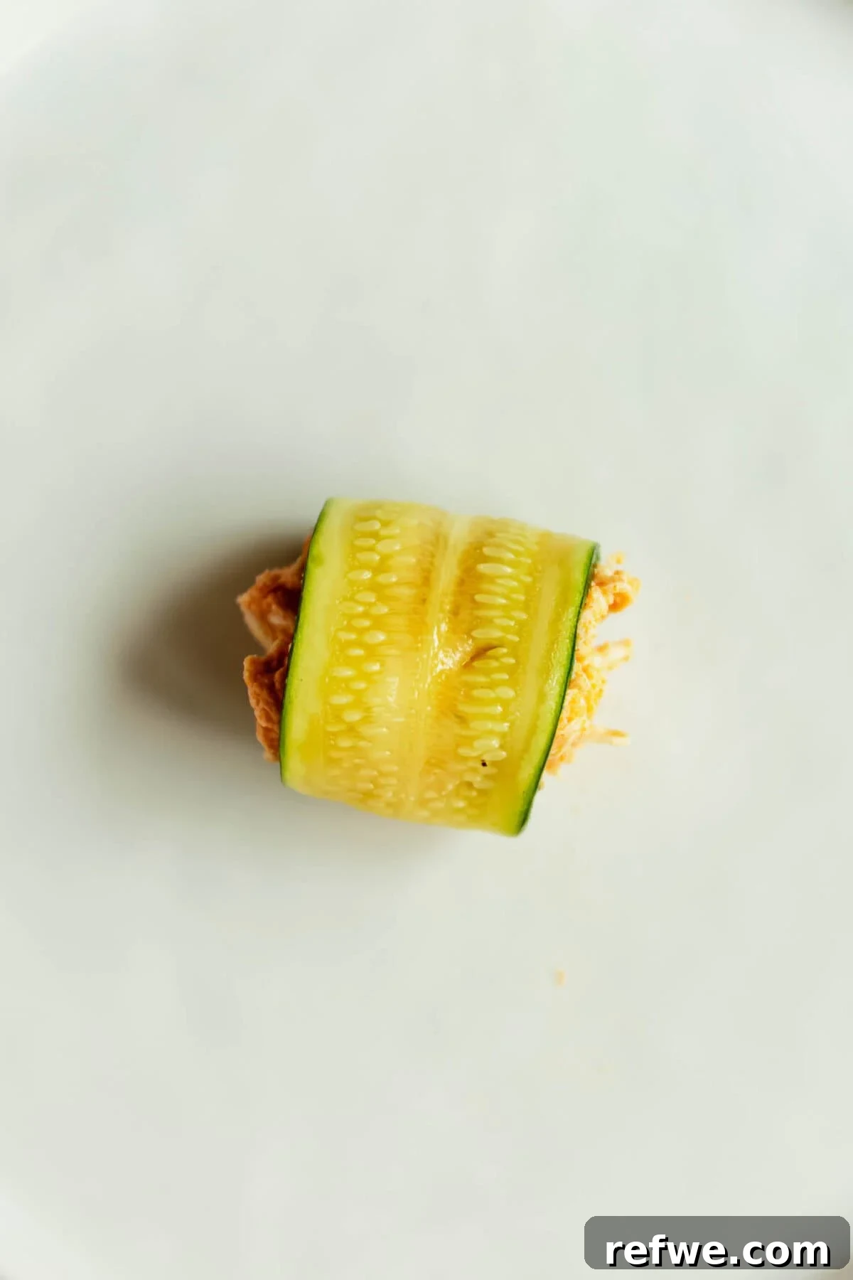 Buffalo Chicken Zucchini Roll-Ups Recipe 9 A rolled up sliced zucchini filled with buffalo chicken filling.