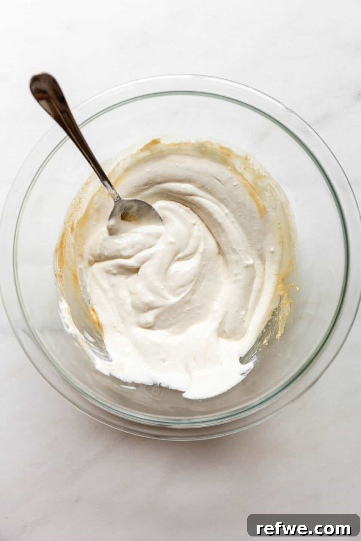 Homemade Cottage Cheese Pop Tarts Recipe 4 Mixing cottage cheese in a clear bowl with a spoon.