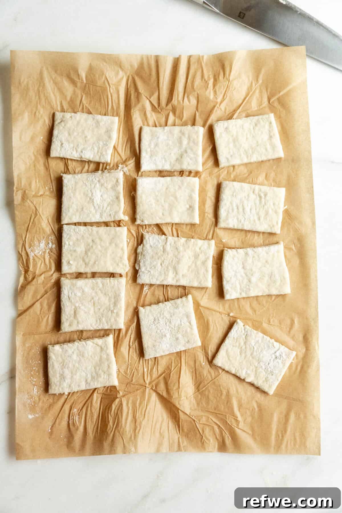 Homemade Cottage Cheese Pop Tarts Recipe 8 Cottage cheese dough cut into small rectangles on parchment paper.