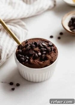 Delicious chocolate chia pudding topped with chocolate chips in a white ramekin.
