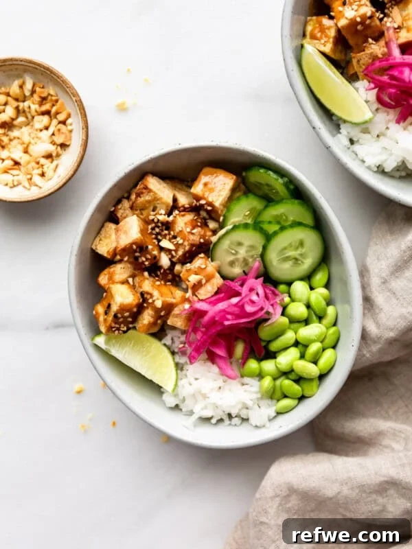 Bang Bang Chicken Bowl Recipe with Spicy Cucumber Salad 13 tofu, cucumber, edamame and pickled onions in a bowl with rice