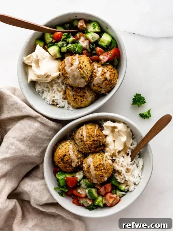 Bang Bang Chicken Bowl Recipe with Spicy Cucumber Salad 14 two falafel bowls with wood spoons in them