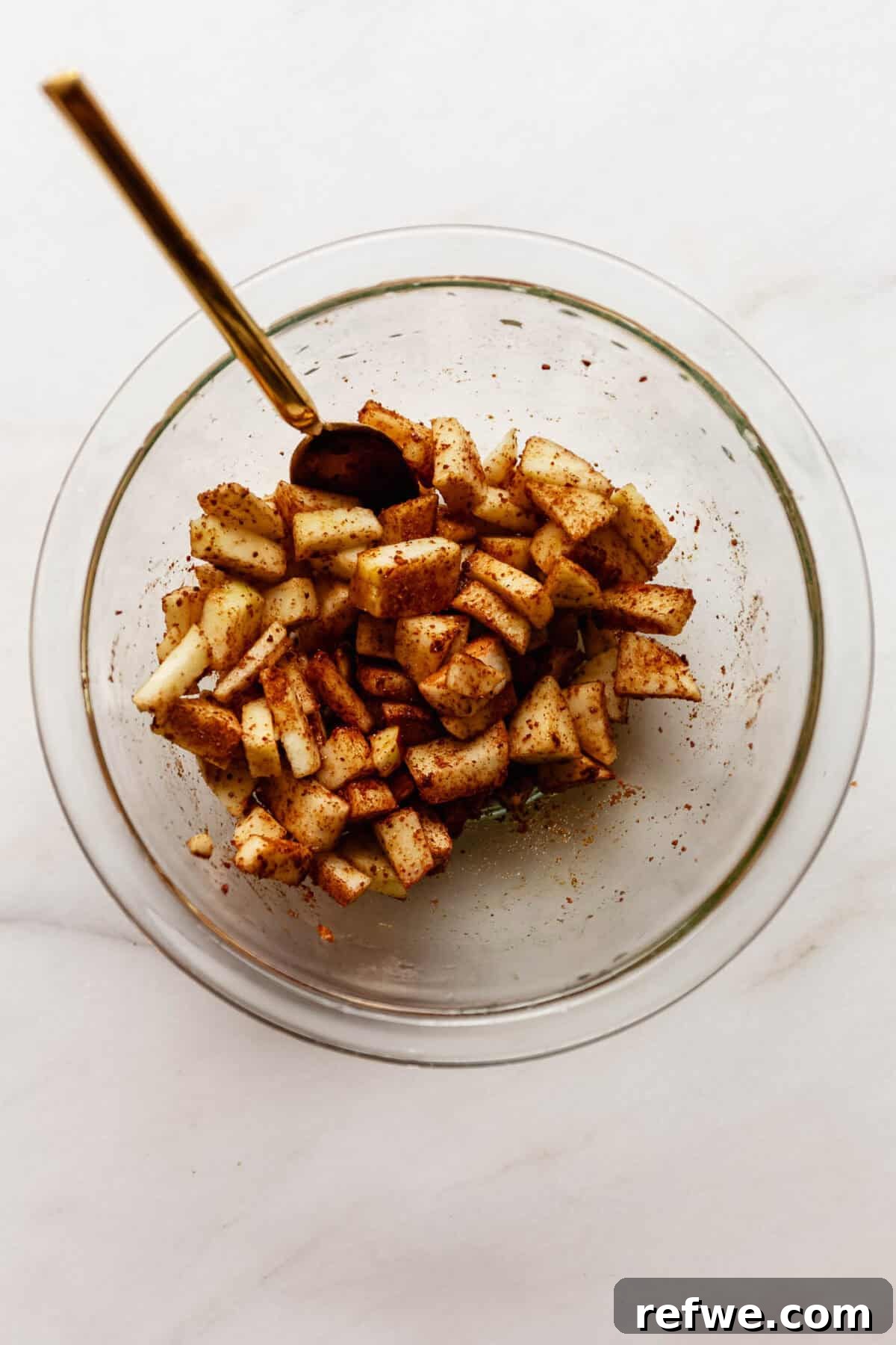 Cottage Cheese Apple Fritters with Maple Cinnamon Glaze 6 Bowl of diced apples tossed in cinnamon before being mixed into the fritter batter.