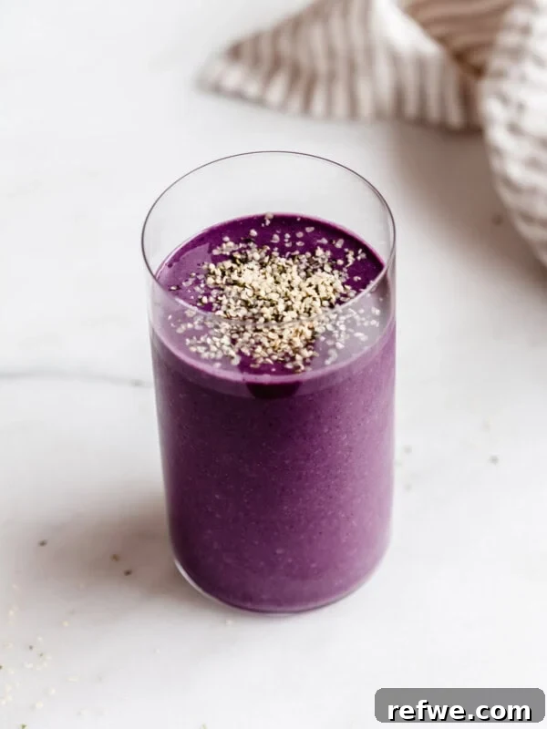 Creamy Greek Yogurt Peanut Butter Mousse Recipe 10 Berry protein smoothie in a tall glass with a striped napkin on the side